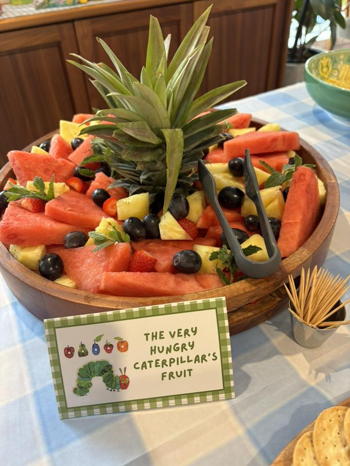 A bowl of watermelon, pineapple, and blueberries themed as The Very Hungry Caterpillar's fruit display.