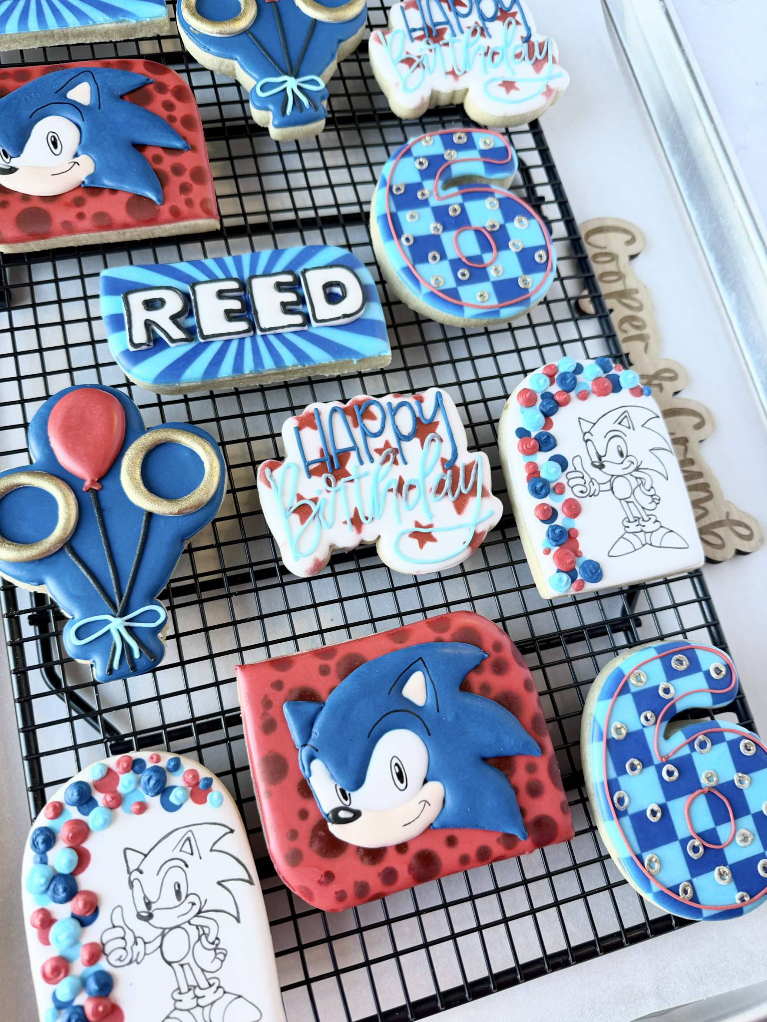 Custom Sonic the Hedgehog themed birthday sugar cookies including a name plaque for Reed and the number six