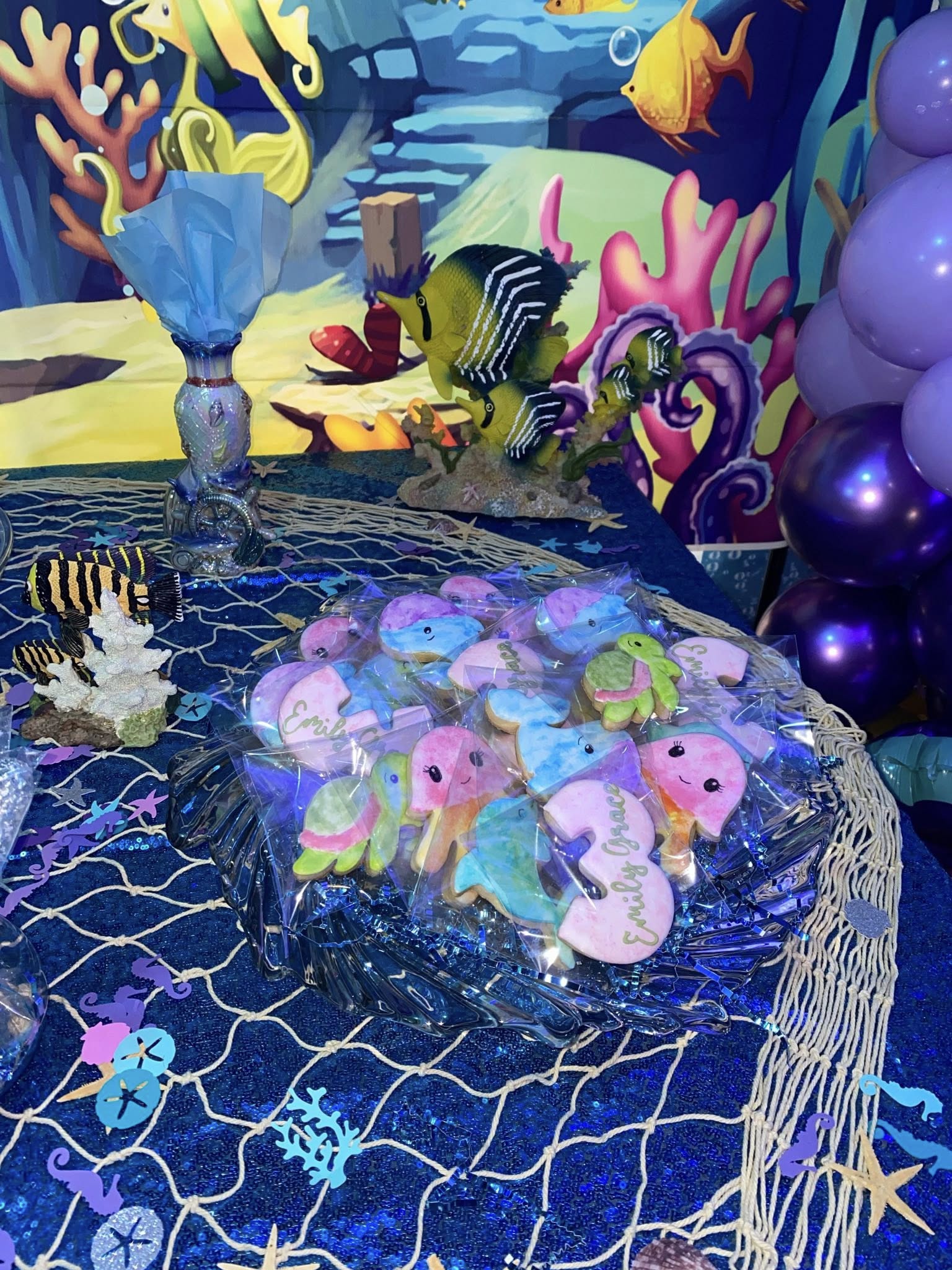 Individually wrapped sea-themed sugar cookies, including number 3 shapes personalized for Emily Grace.