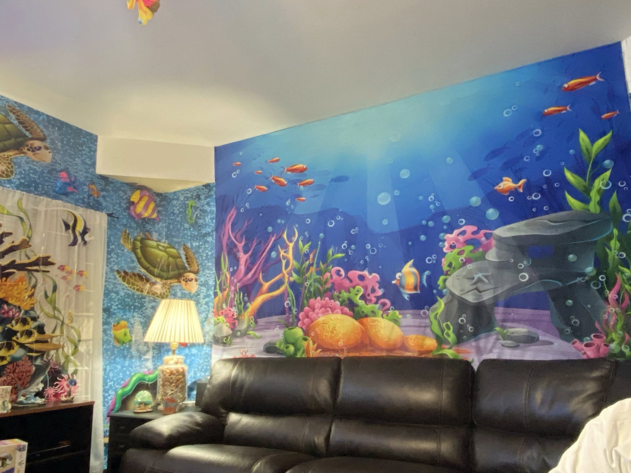 Colorful underwater ocean mural on home office wall featuring sea turtles and coral reef scenery.
