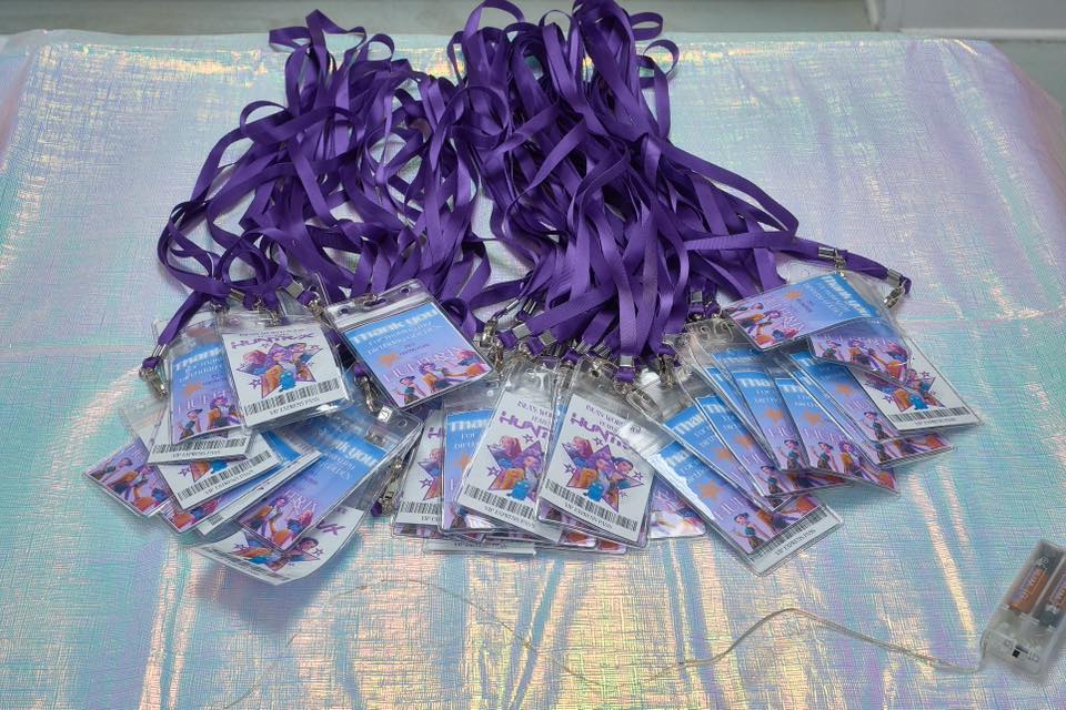 Collection of purple VIP lanyards with printed graphic event passes