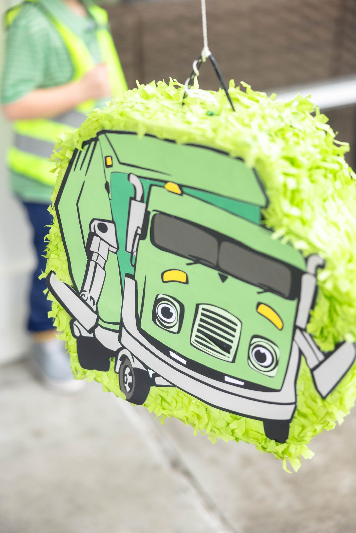Green garbage truck themed piñata with lime green fringe.