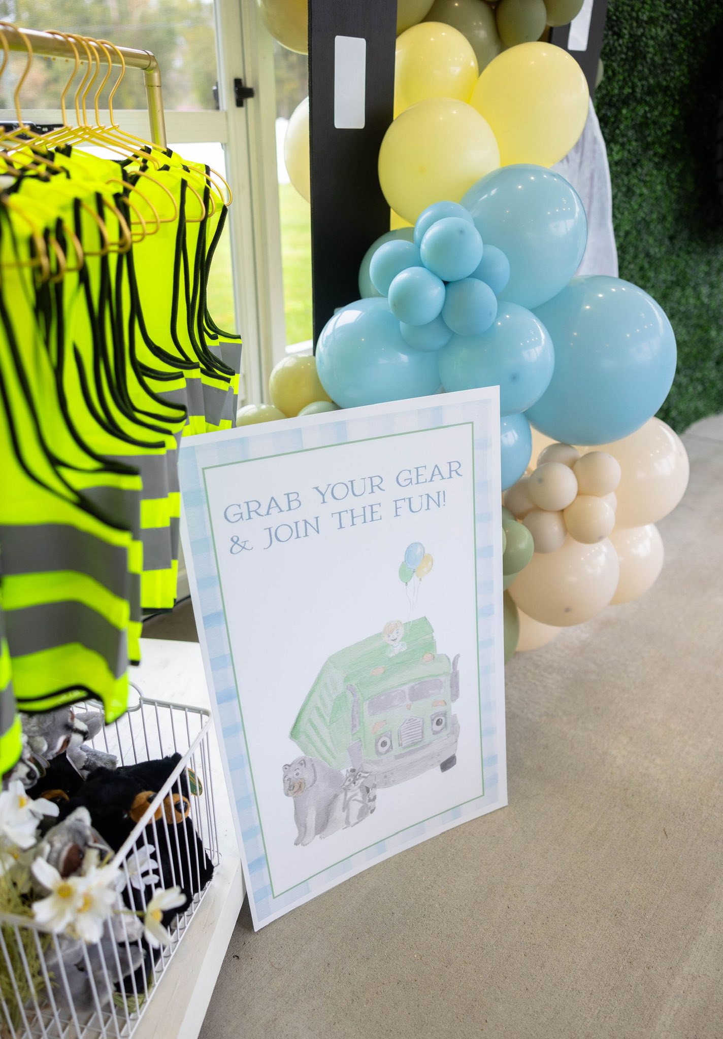 Grab Your Gear and Join The Fun sign with a garbage truck illustration next to yellow safety vests