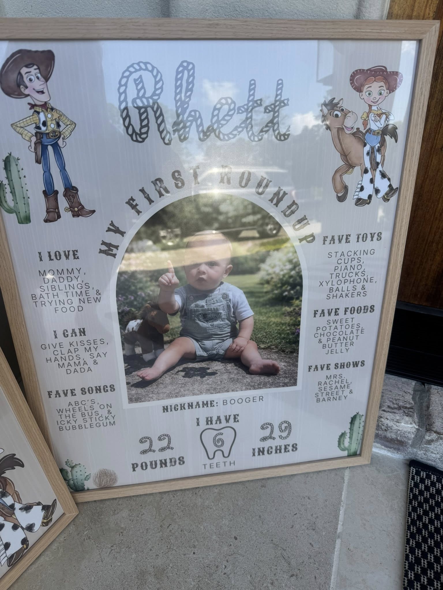 Toy Story western-themed first birthday milestone poster for a baby named Rhett with photo and fun facts.