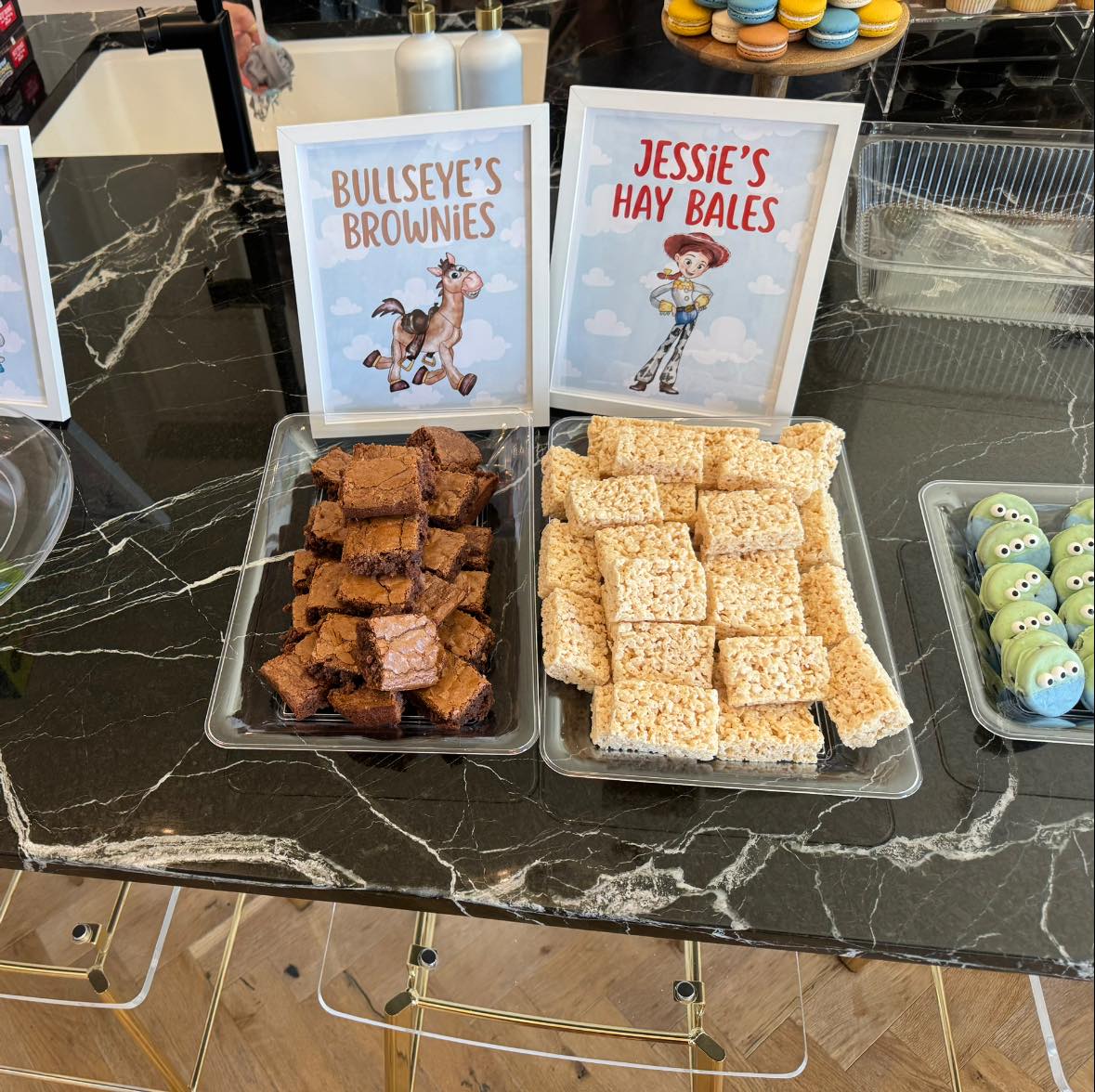 Table display with chocolate Bullseye brownies and rice cereal Jessie's hay bales with printed themed signs.