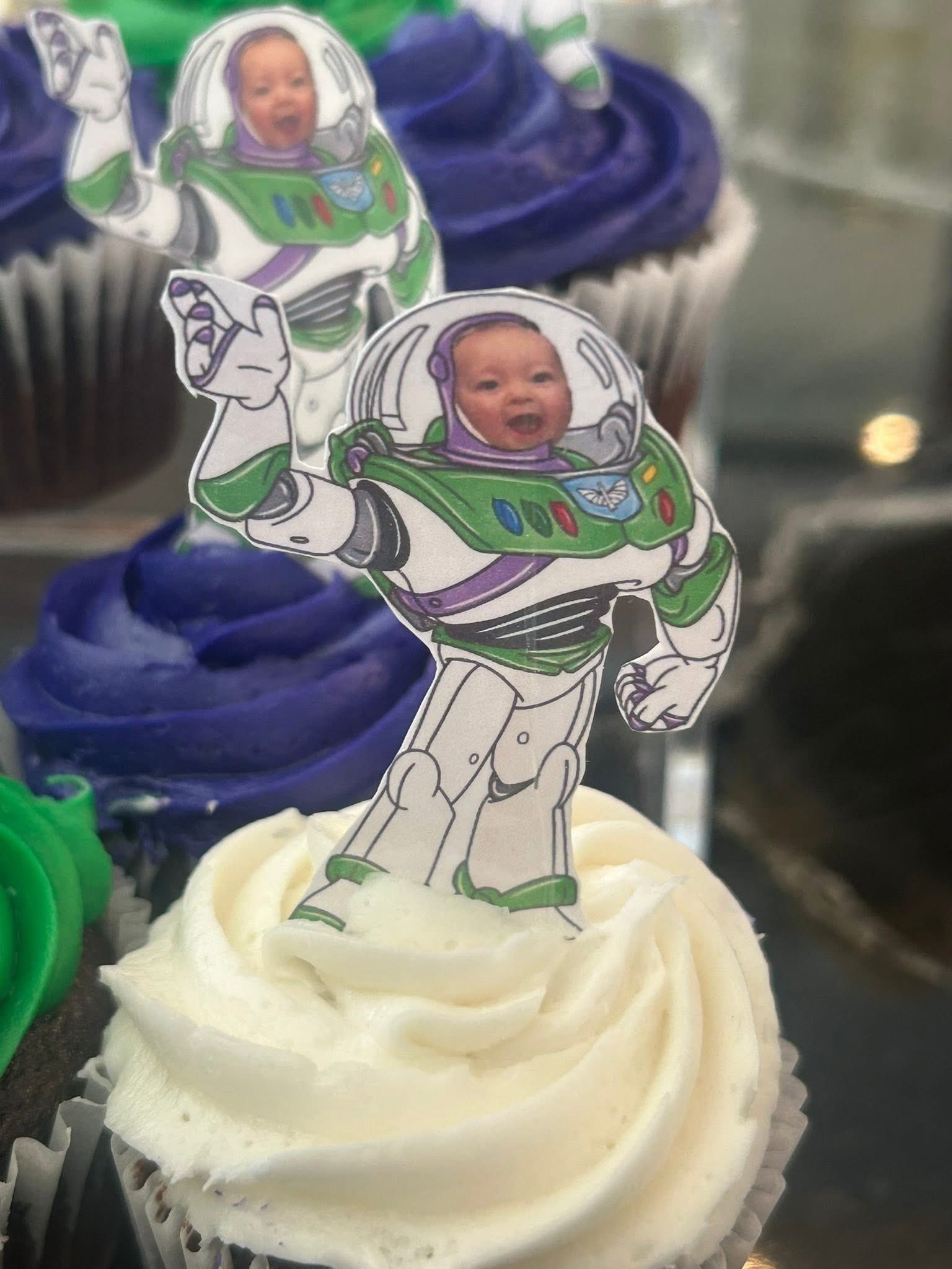 Customized Buzz Lightyear cupcake topper featuring a baby's face on frosted cupcakes