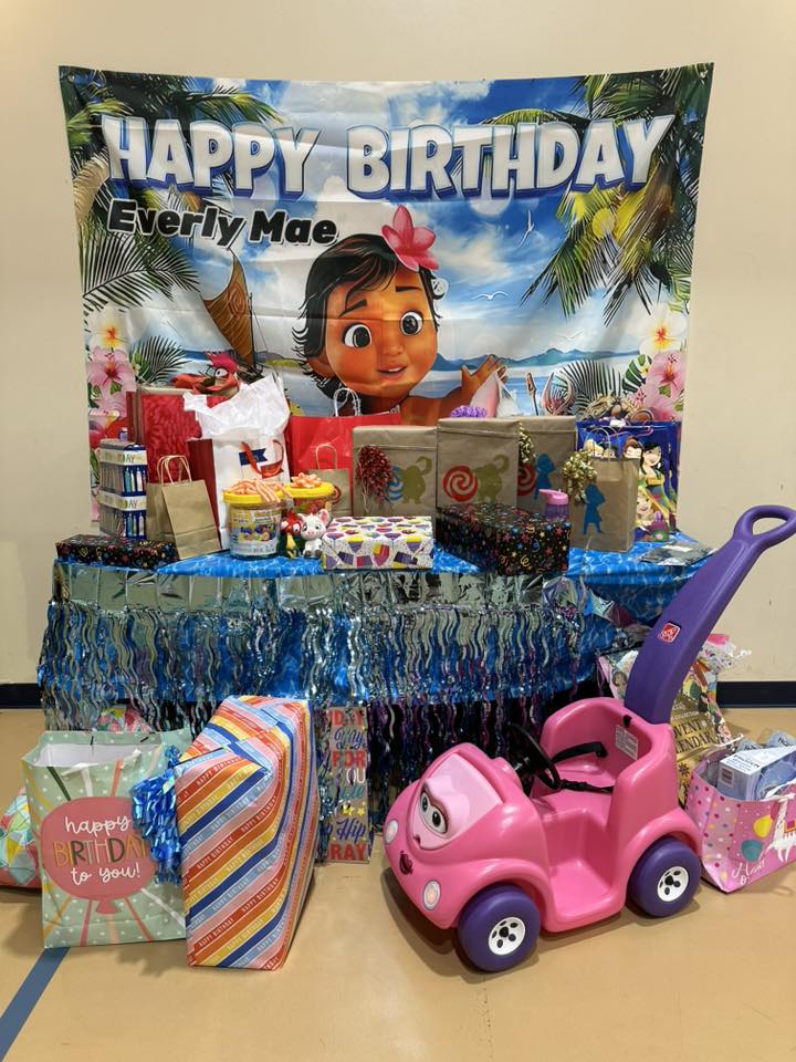 Moana themed birthday party setup with personalized backdrop and birthday presents for Everly Mae.