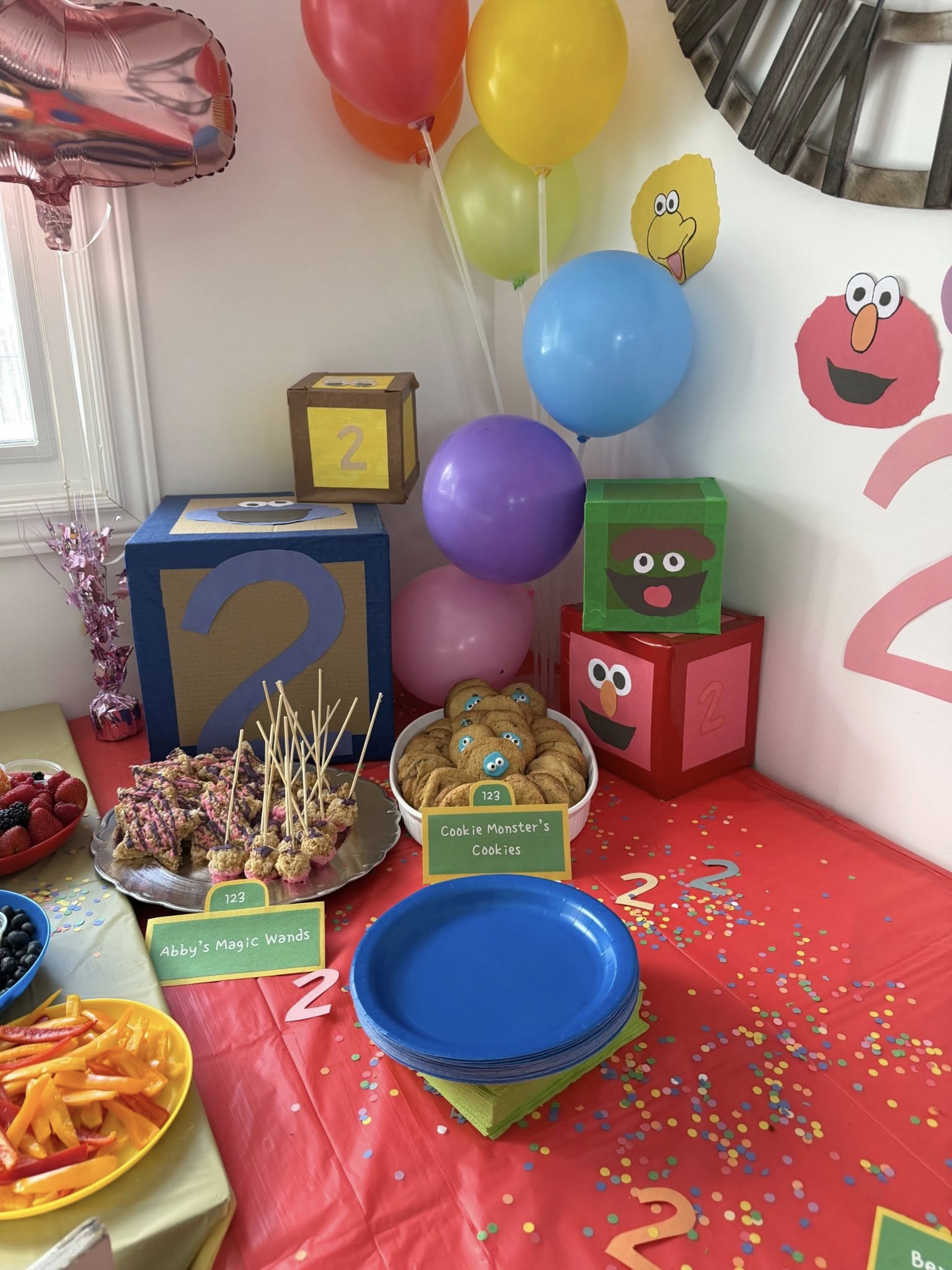 Sesame Street-themed second birthday party dessert table with Sesame Street character decorations and cookies.