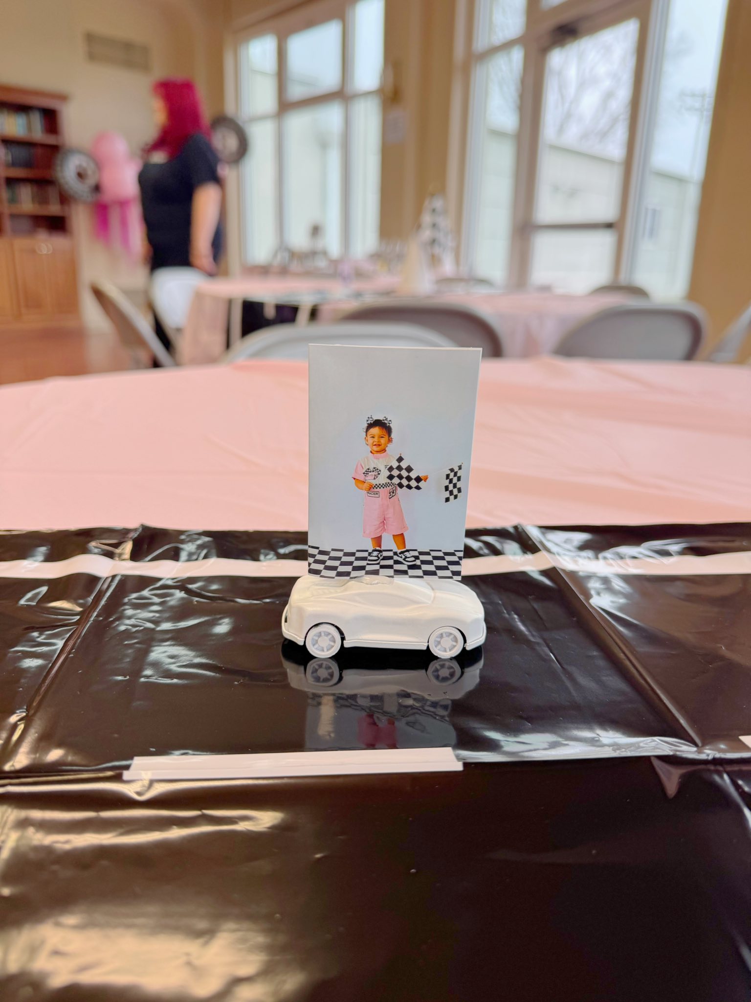 White sports car card holder featuring a racing-themed photo of a child holding a checkered flag.