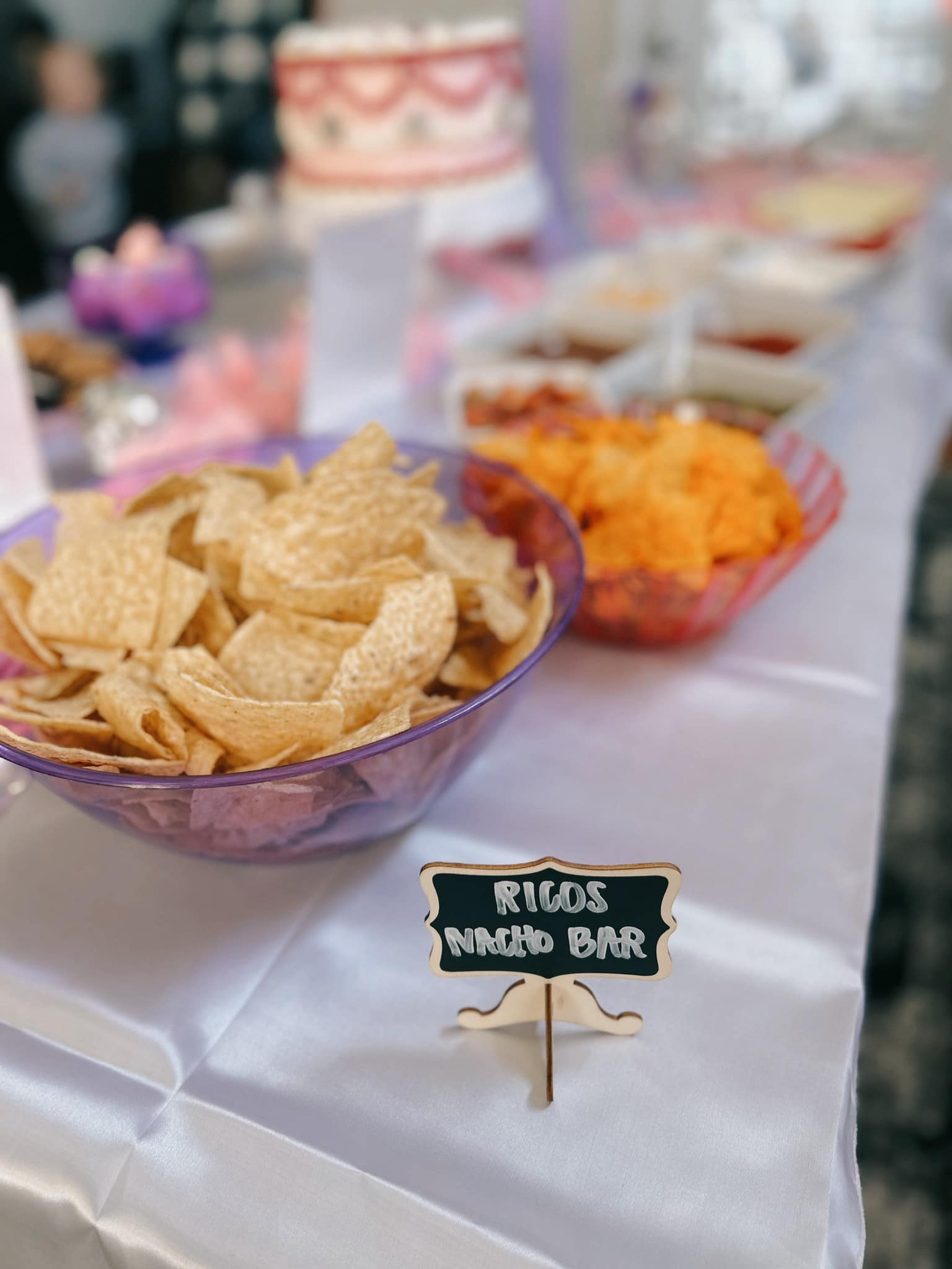 Ricos Nacho Bar with bowls of tortilla chips and various toppings