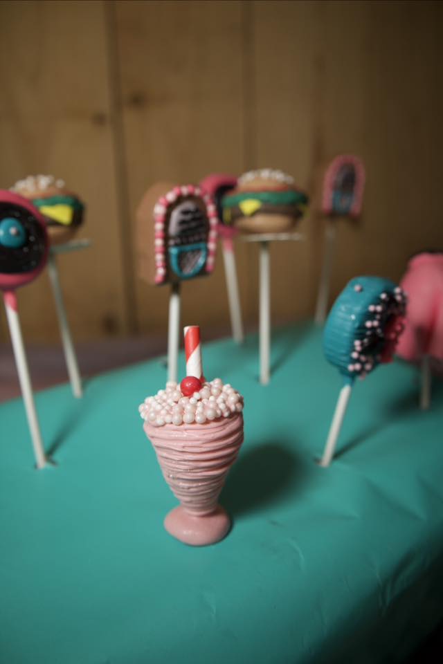 Assorted 1950s diner-themed cake pops including a milkshake, hamburger, and jukebox design.