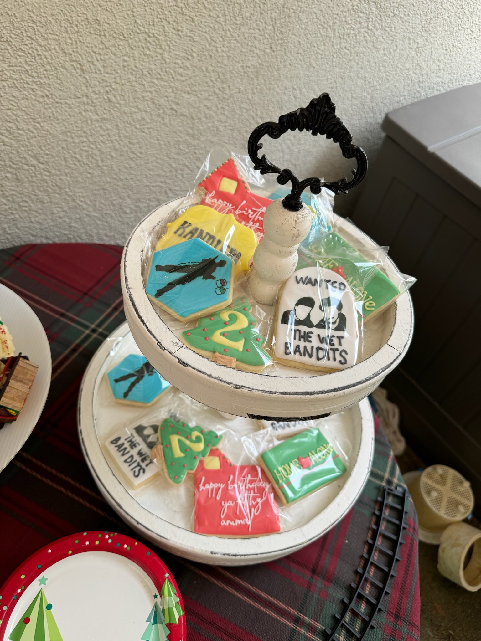 Home Alone themed birthday cookies on a two-tier white tray