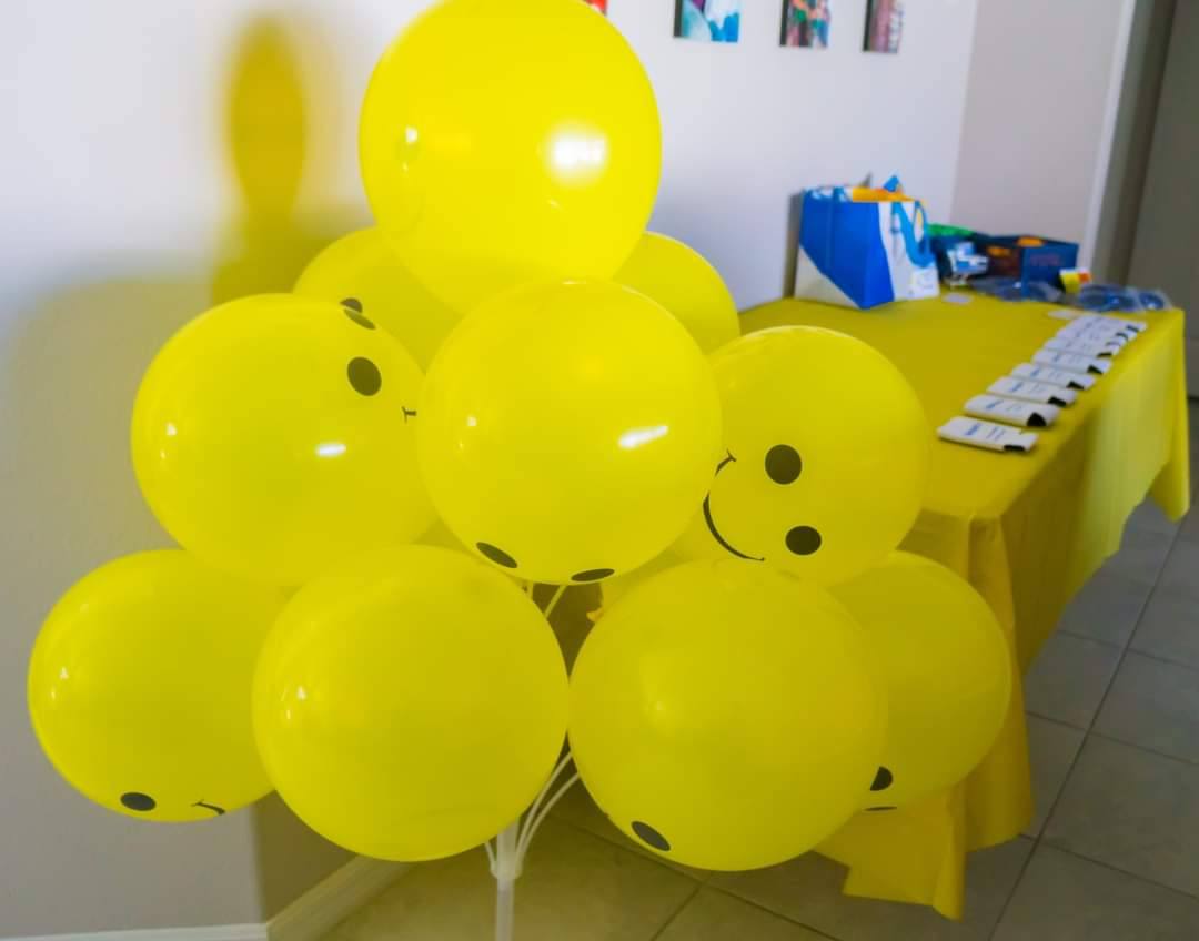 Bunch of yellow smiley face balloons at a birthday party