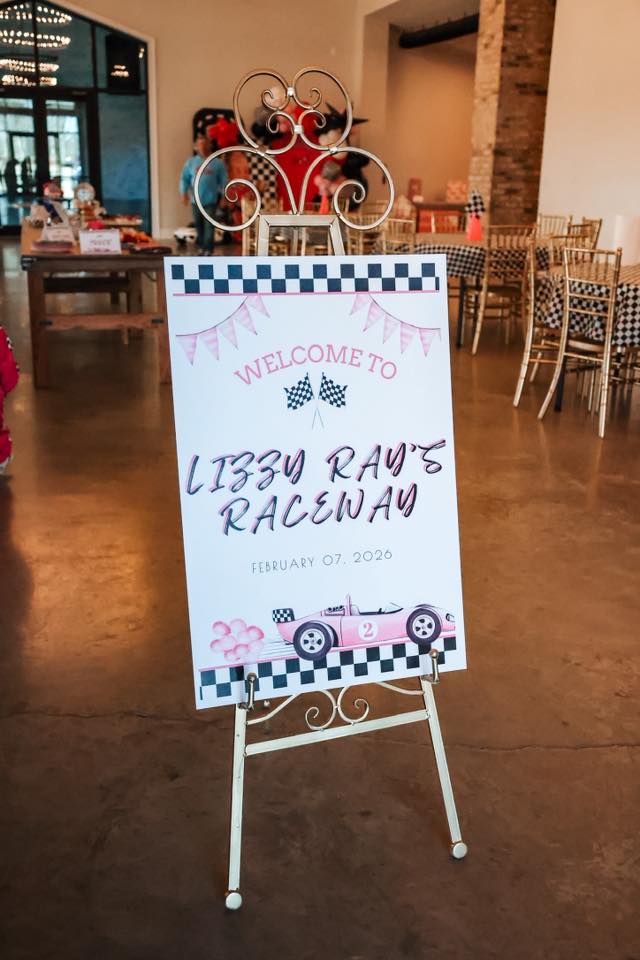 Welcome sign for Lizy Ray's Raceway themed birthday party featuring a pink race car.