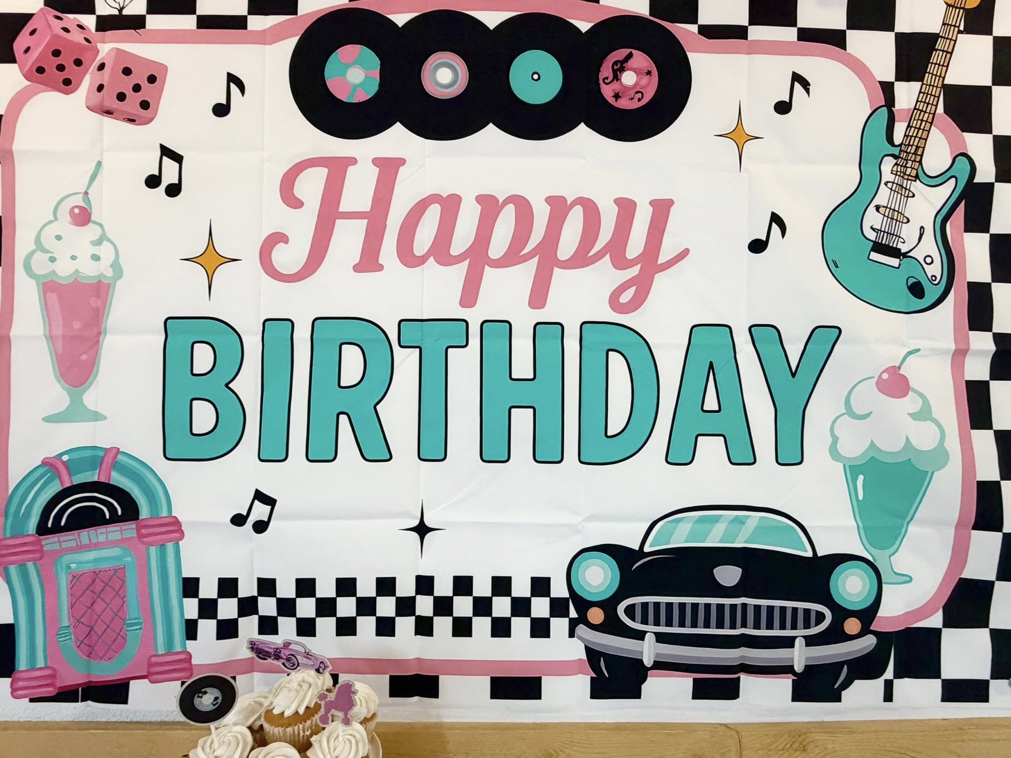 1950s rock and roll themed Happy Birthday party banner with records, guitar, jukebox, car, and milkshakes.