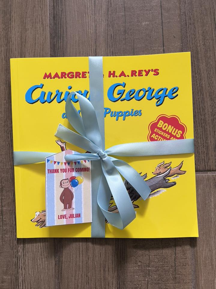 Curious George and the Puppies book gift-wrapped with a party favor thank you tag from Julian.