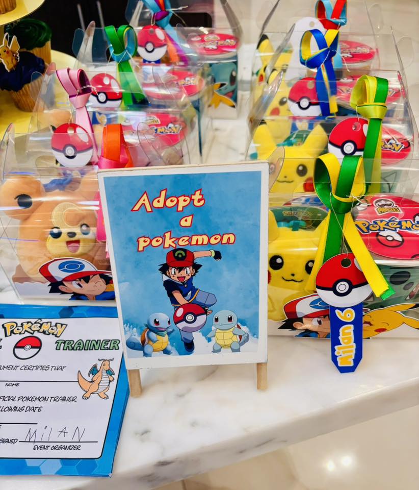 Adopt a Pokemon birthday party favor display with character boxes and trainer certificates.