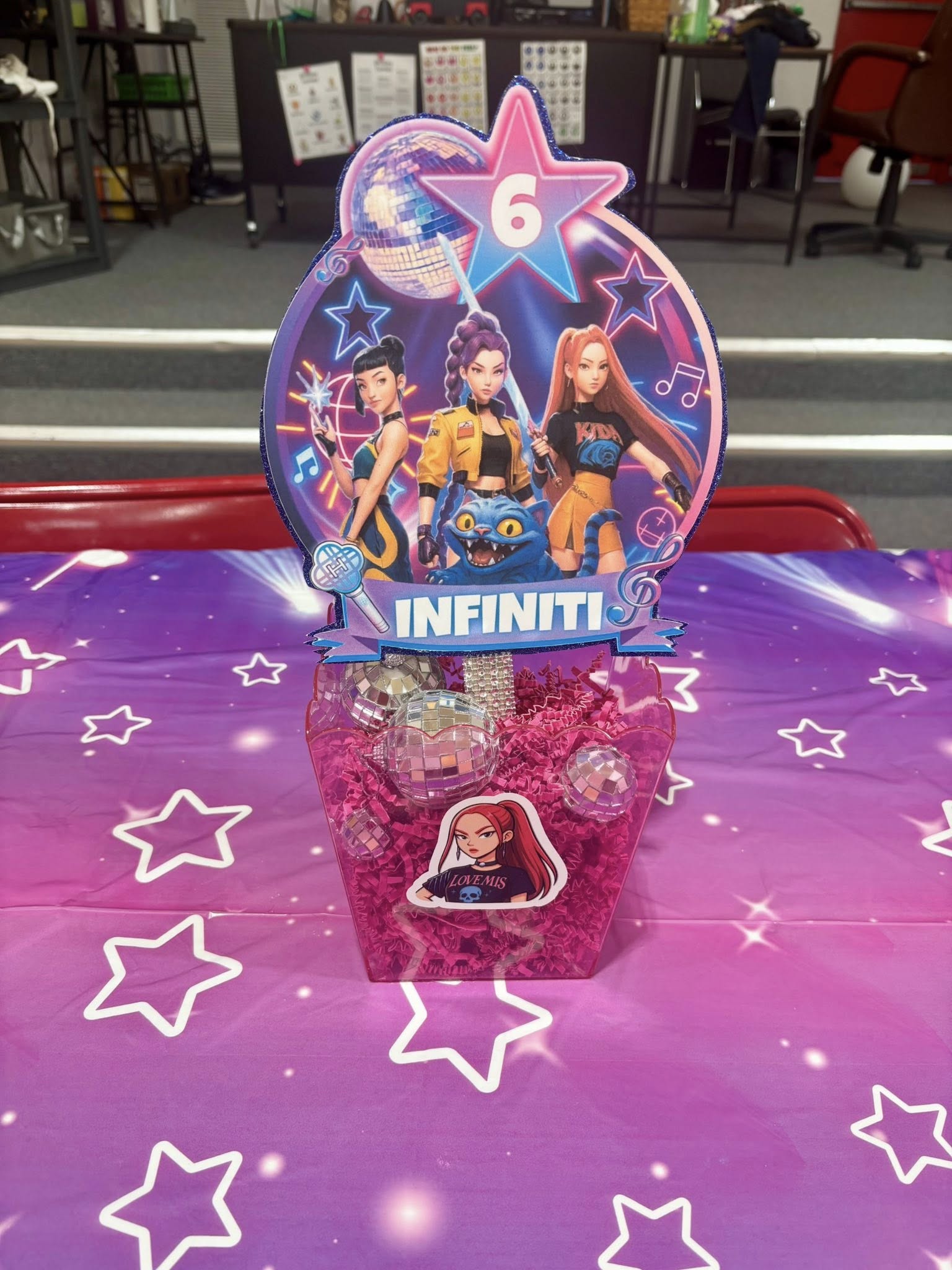 Pop star themed table centerpiece with a personalized name card and mini disco balls.