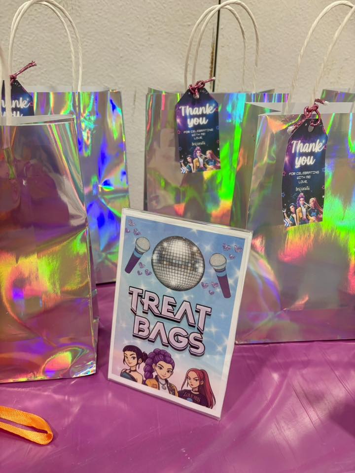 Iridescent party favor bags with custom thank you tags and a matching disco-themed signage.