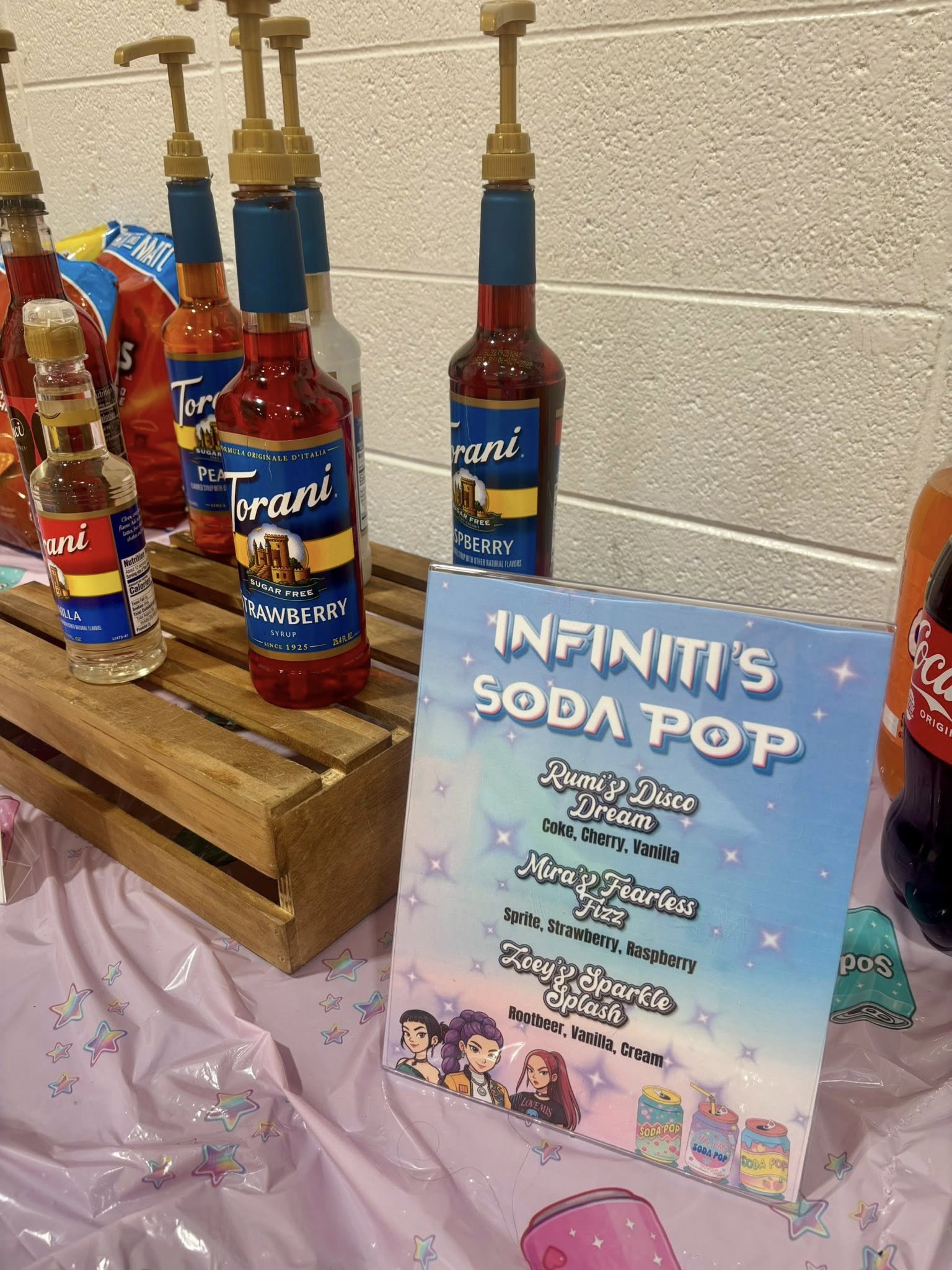 Display of Torani syrup flavors with a menu sign for custom soda pop combinations.