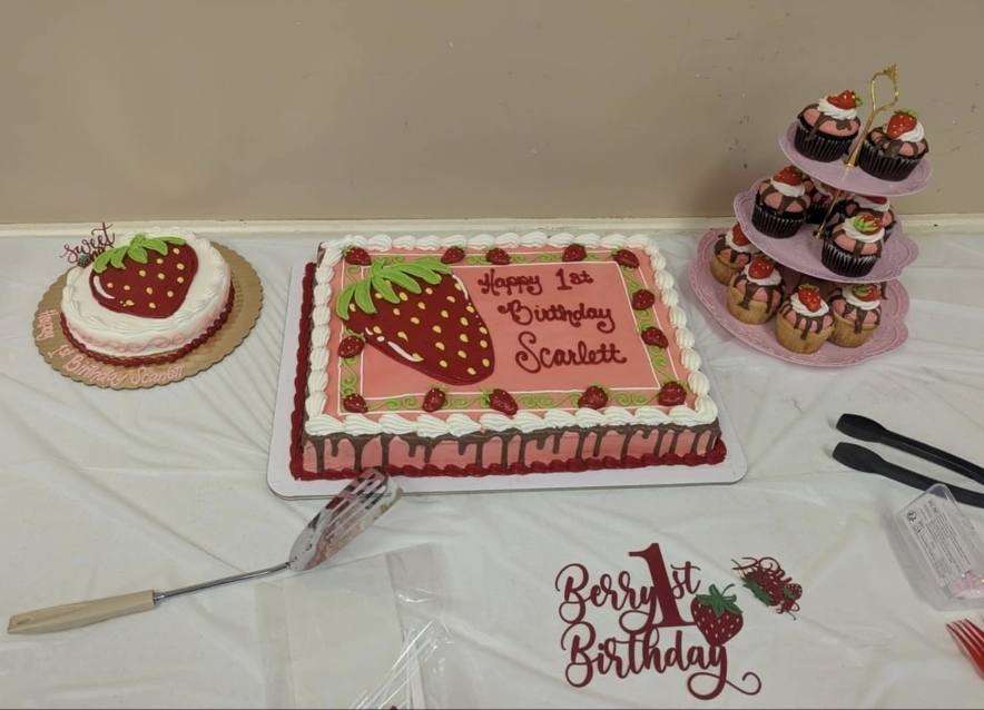 Strawberry-themed 1st birthday cake with matching cupcakes and smash cake