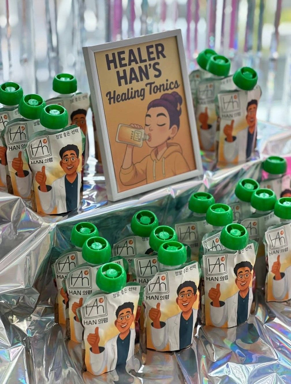 Healer Han's Healing Tonics display with illustrated character snack pouches on a silver surface.