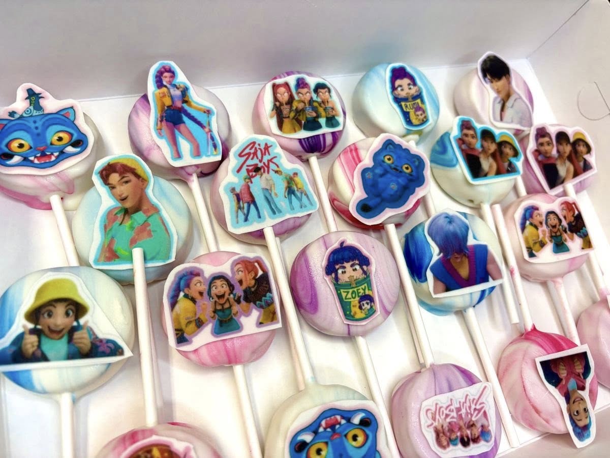 Box of cake pops decorated with edible pop culture character images and logos.