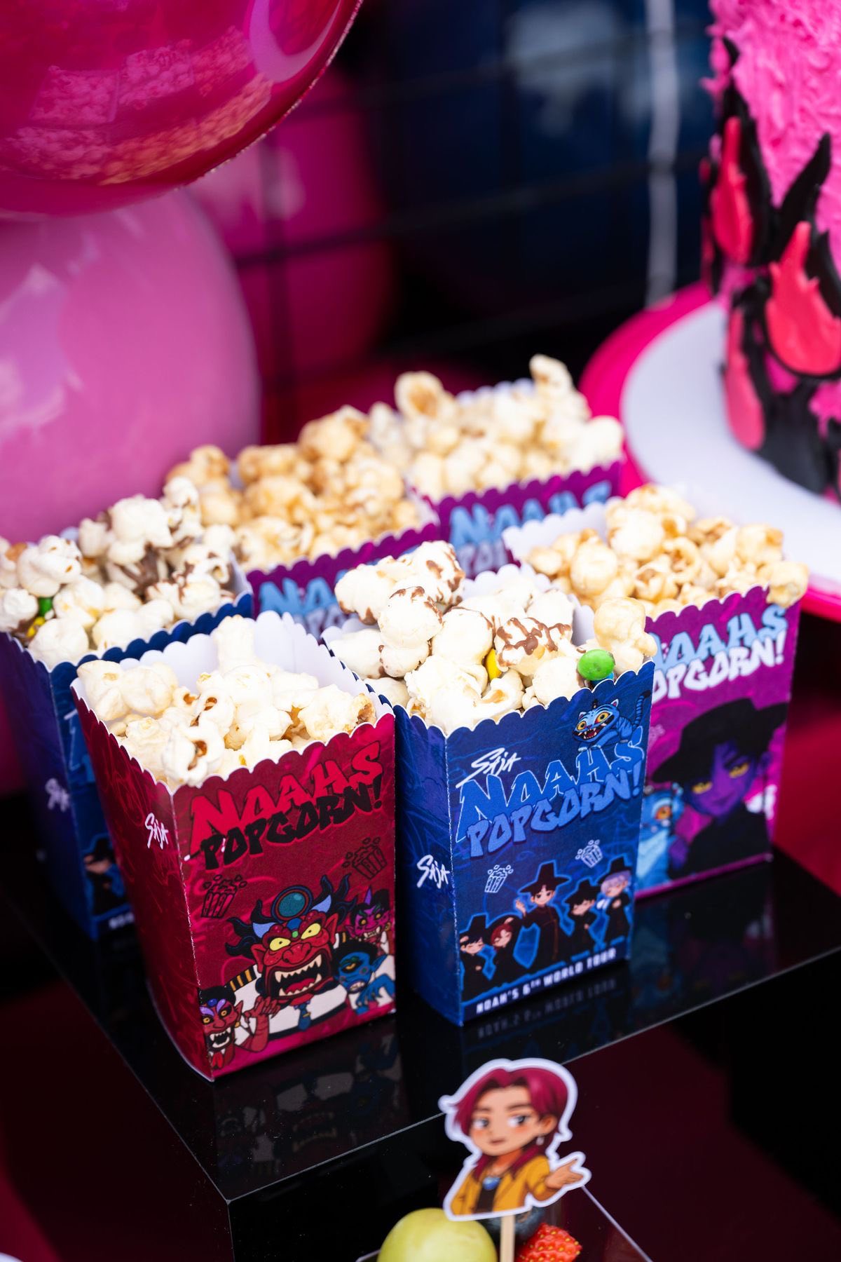 Popcorn boxes branded with custom Naahs Popcorn graphics for a themed event.