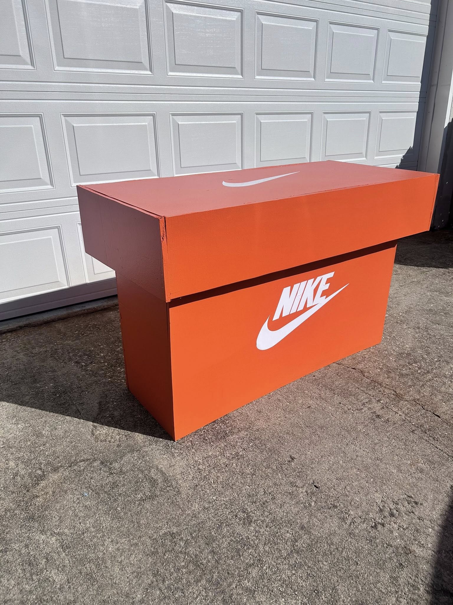 Custom-made large orange wooden storage chest designed to look like a Nike shoebox.