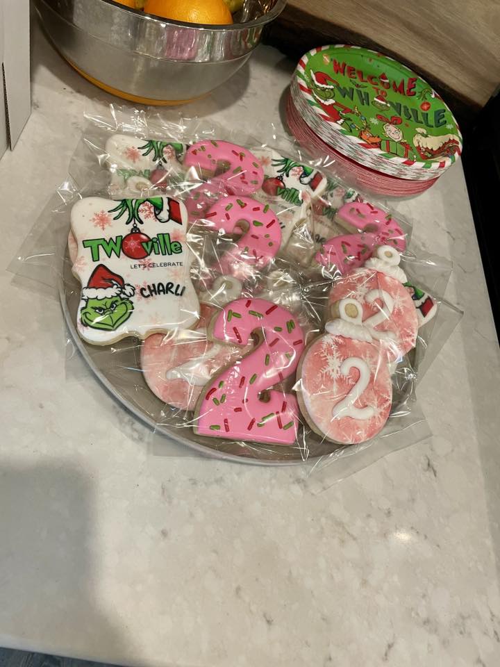 Platter of custom Grinch-themed birthday cookies featuring Twoville lettering and number two shapes.
