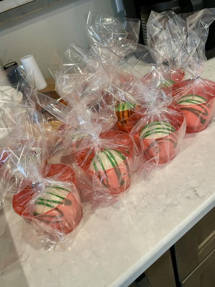 Set of packaged strawberry-themed chocolate covered treats in clear bags