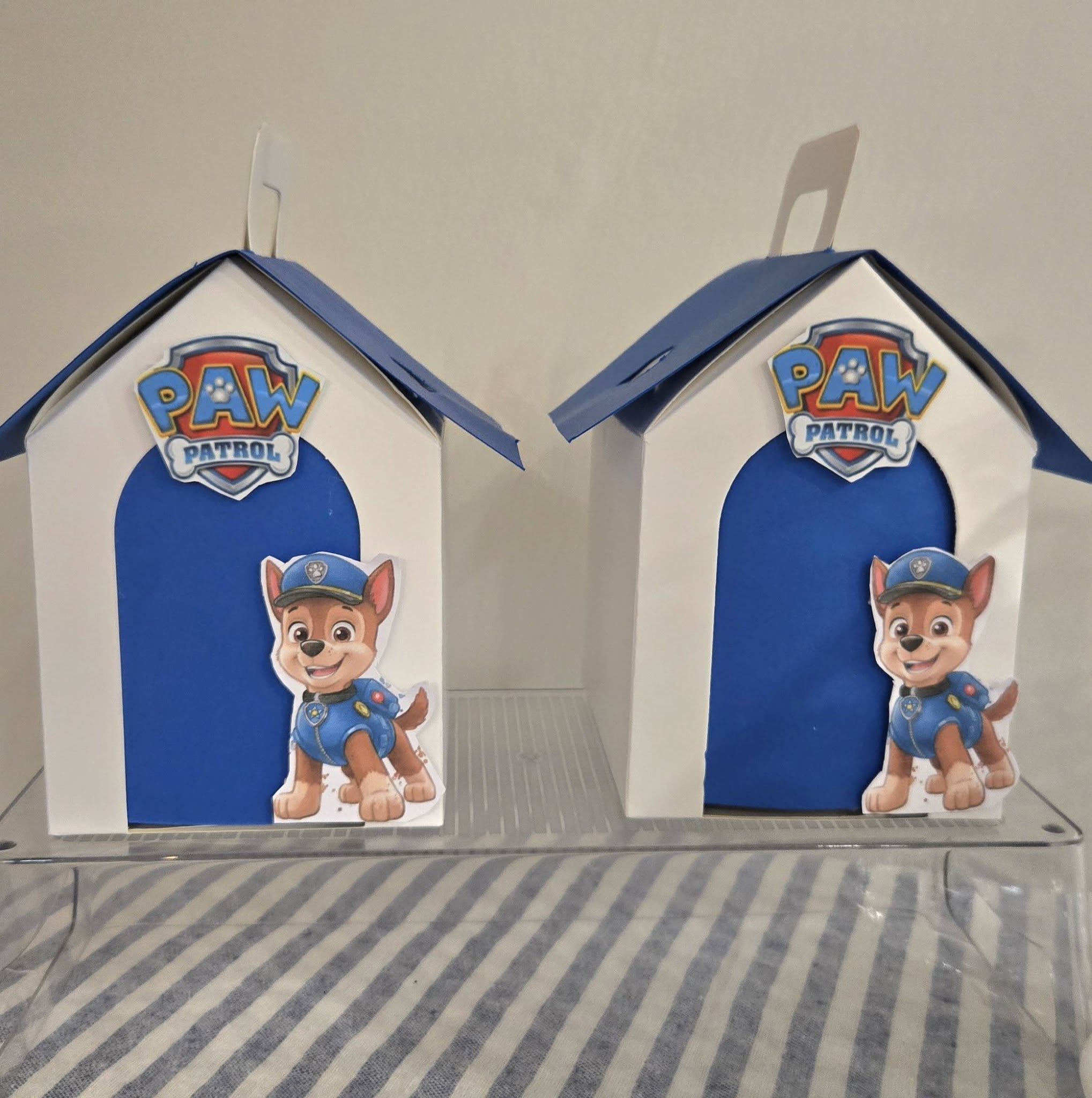 Two PAW Patrol Chase theme dog house treat boxes with blue roofs