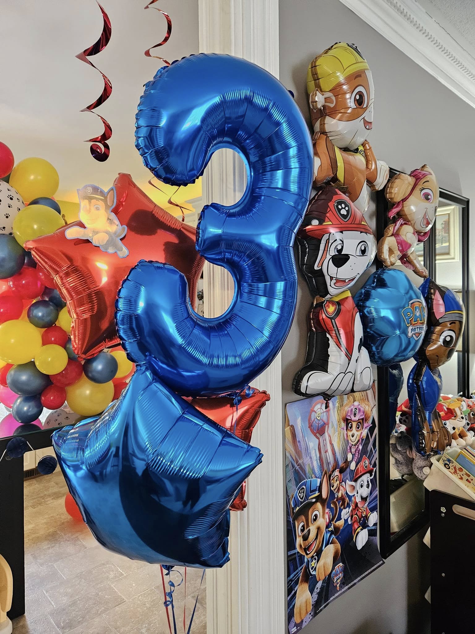 Blue number three helium balloon with Paw Patrol character balloons and party decorations