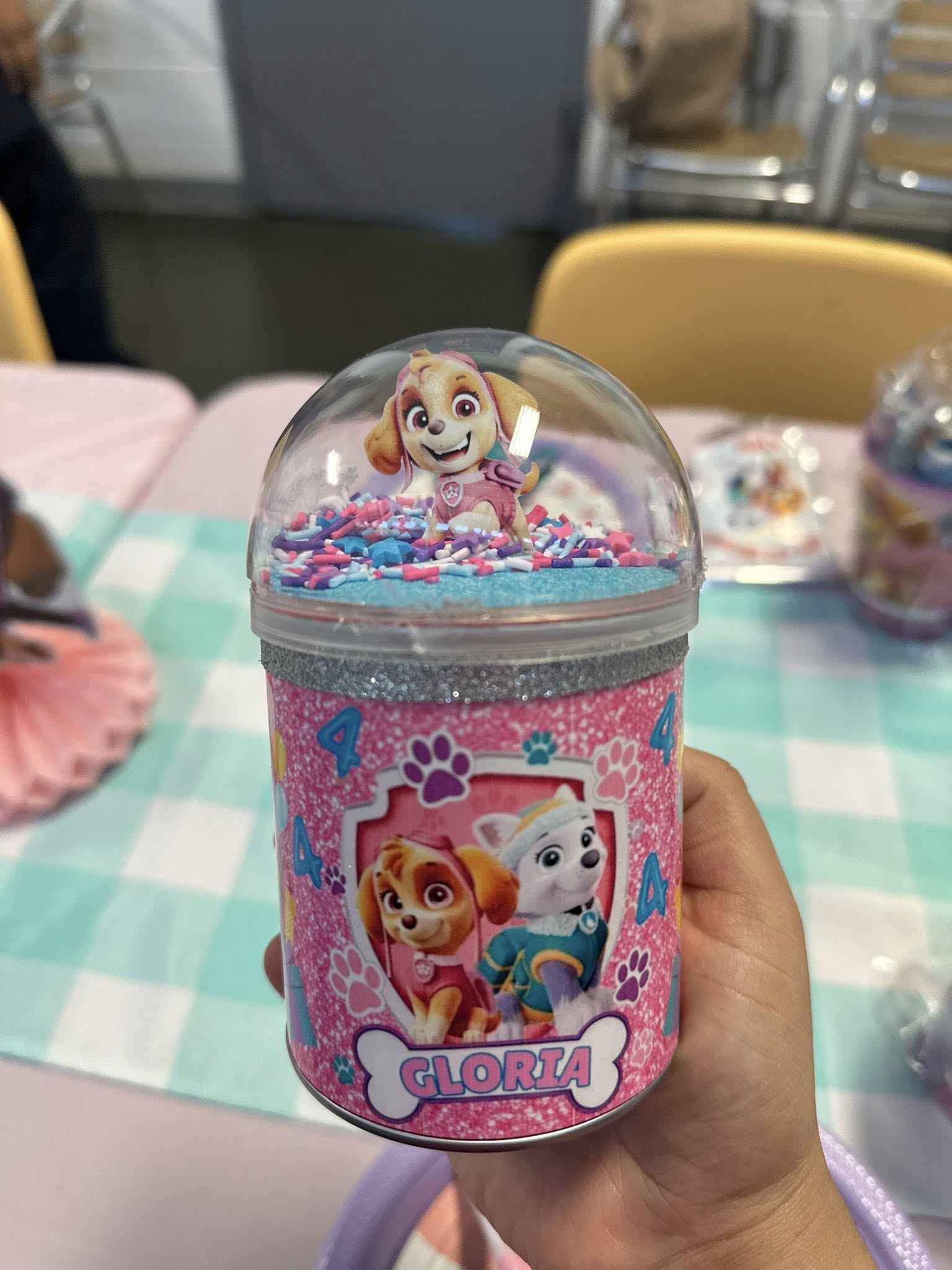 Custom Paw Patrol themed shaker party favor container labeled Gloria with Skye figurine