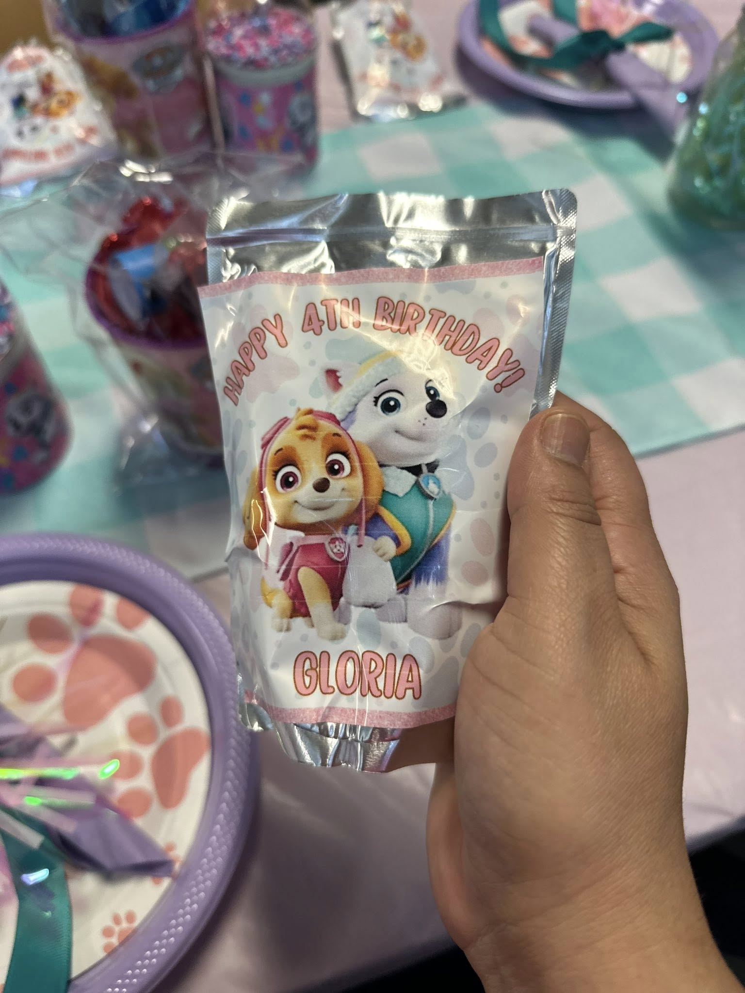 Personalized Paw Patrol birthday party favor pouch with Skye and Everest, labeled Gloria and Happy 4th Birthday