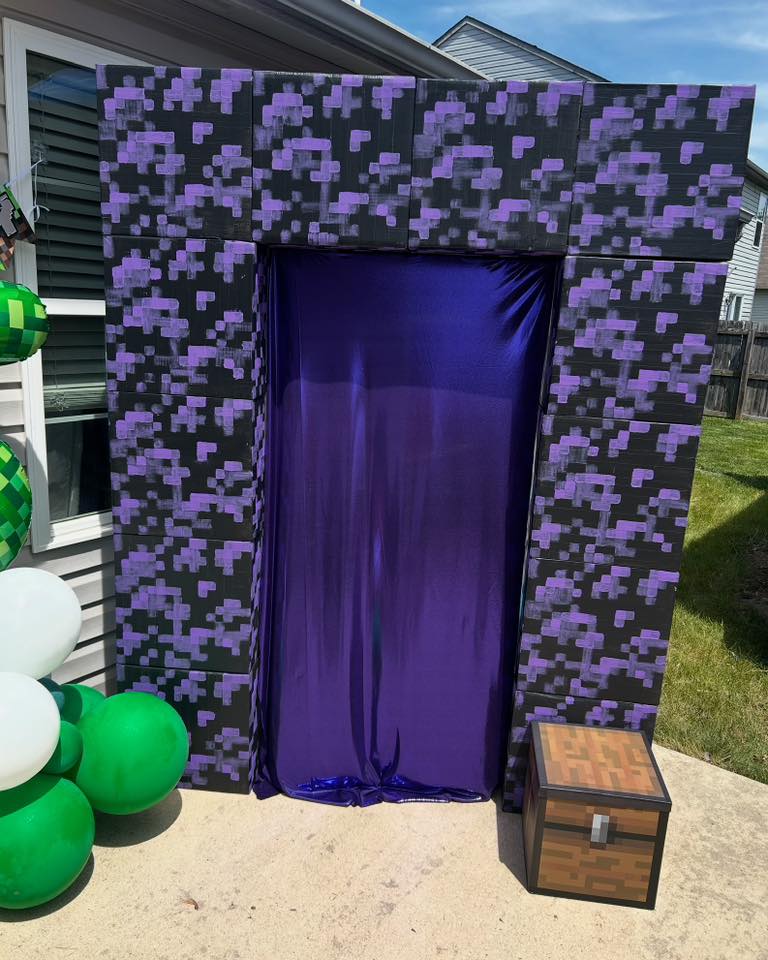 Minecraft Nether portal party backdrop decoration with a purple fabric entrance