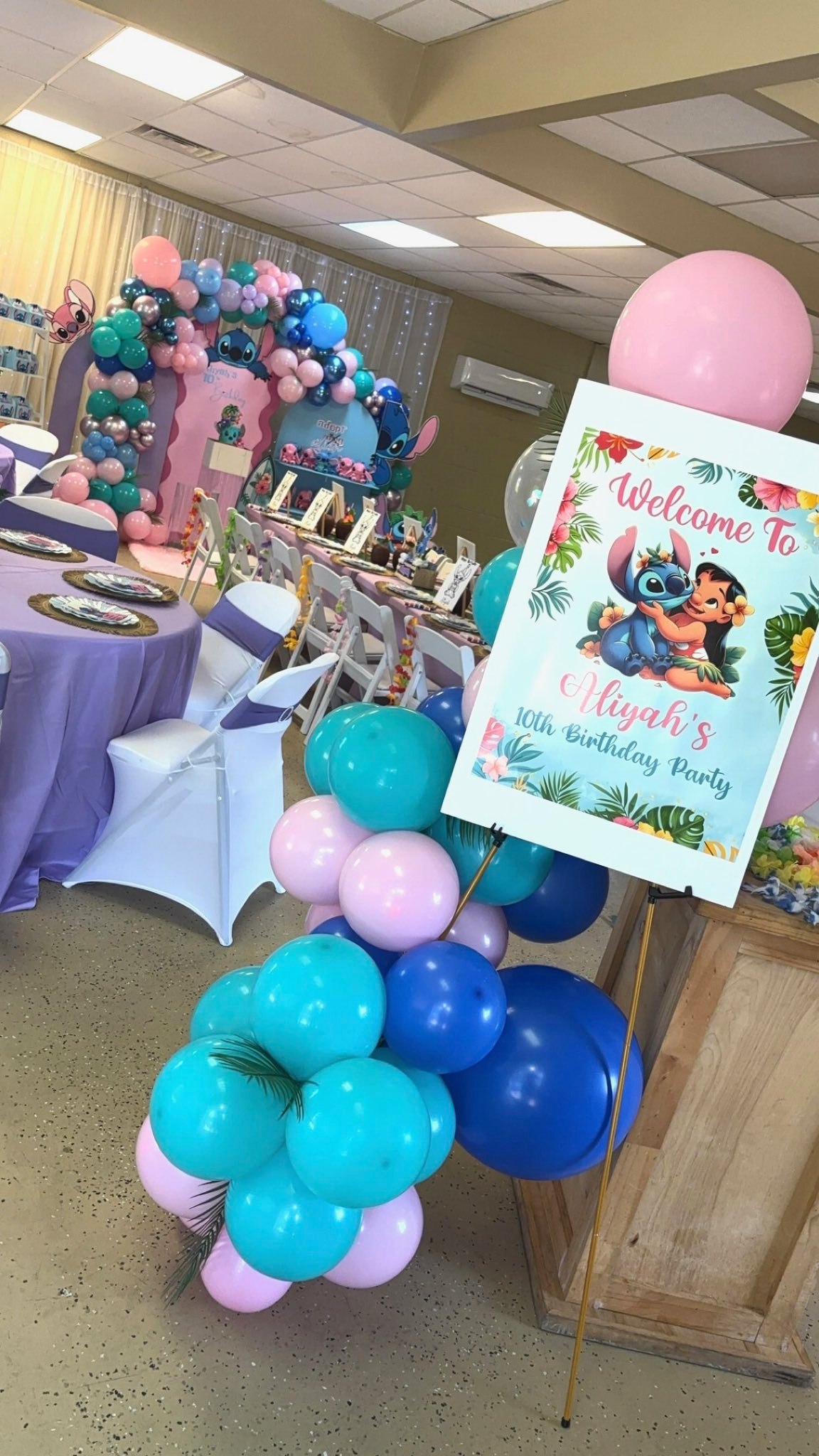 Welcome sign for Aliyah's 10th birthday party featuring Lilo and Stitch with tropical balloon arch decor.
