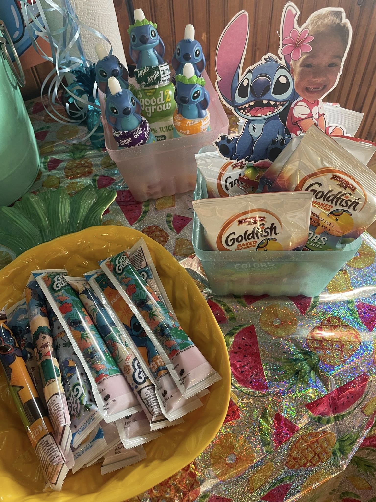 Stitch-themed party favors including Go-Gurt tubes and Goldfish snack packs in decorative bowls.