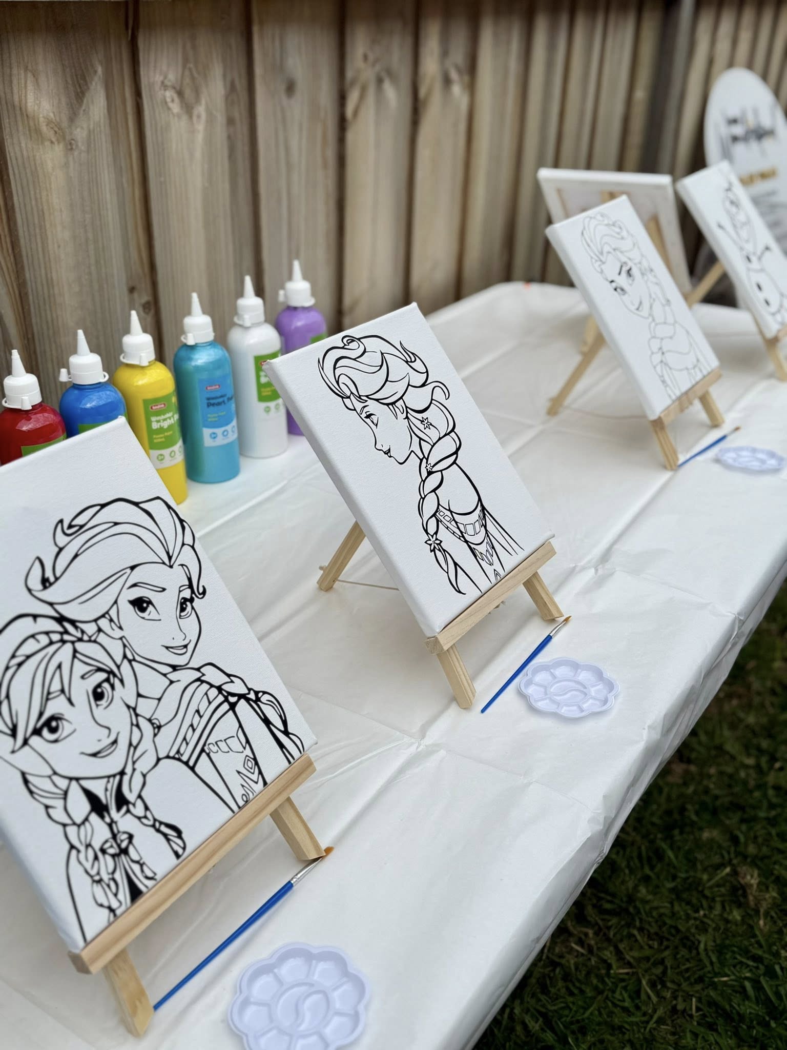 Frozen character canvas party kit with mini easels, paint brushes, and paint bottles ready for kids painting
