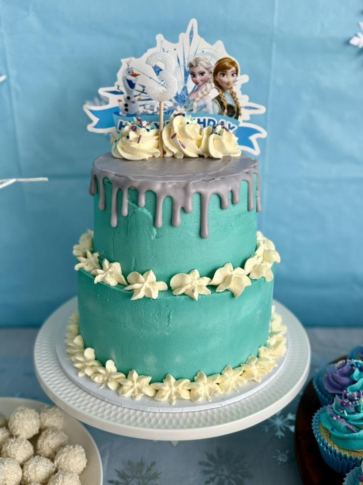 Two-tier teal Frozen-themed birthday cake with silver drip and a number 3 topper.