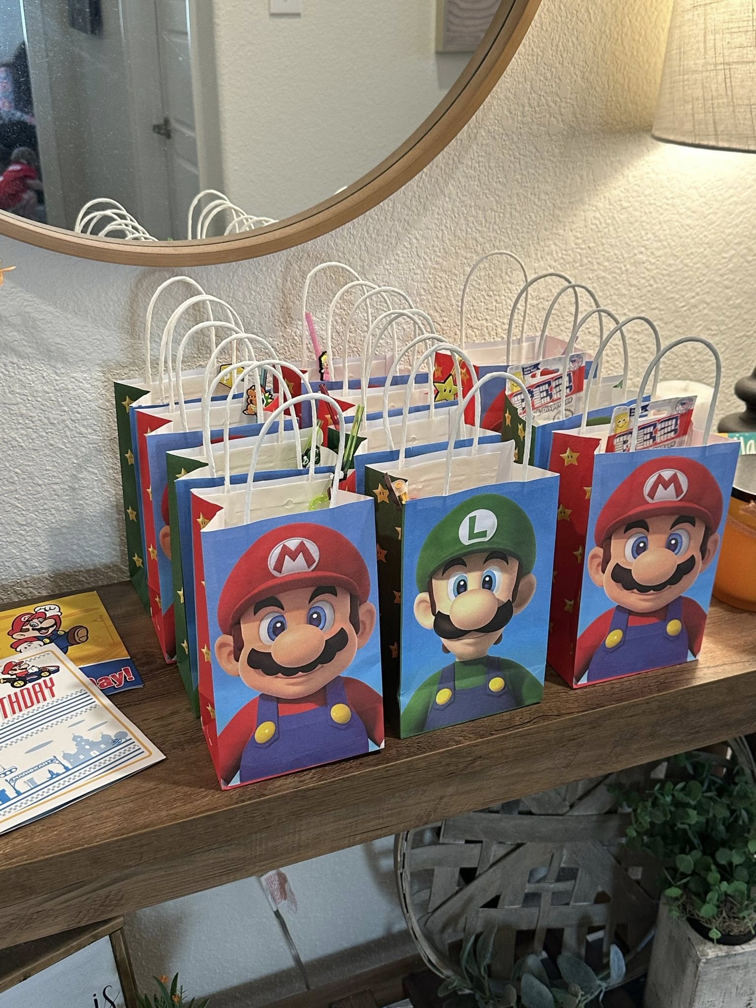 Collection of Super Mario themed goody bags for a party featuring Mario and Luigi illustrations