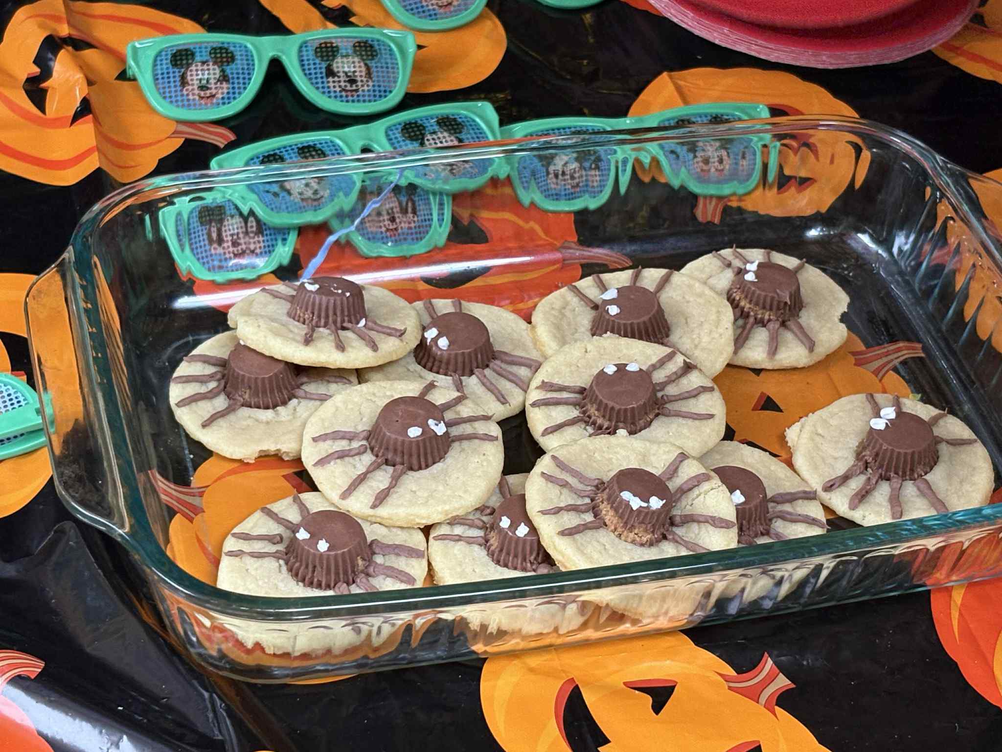 Sugar cookies decorated like spiders using miniature chocolate peanut butter cups and frosting legs