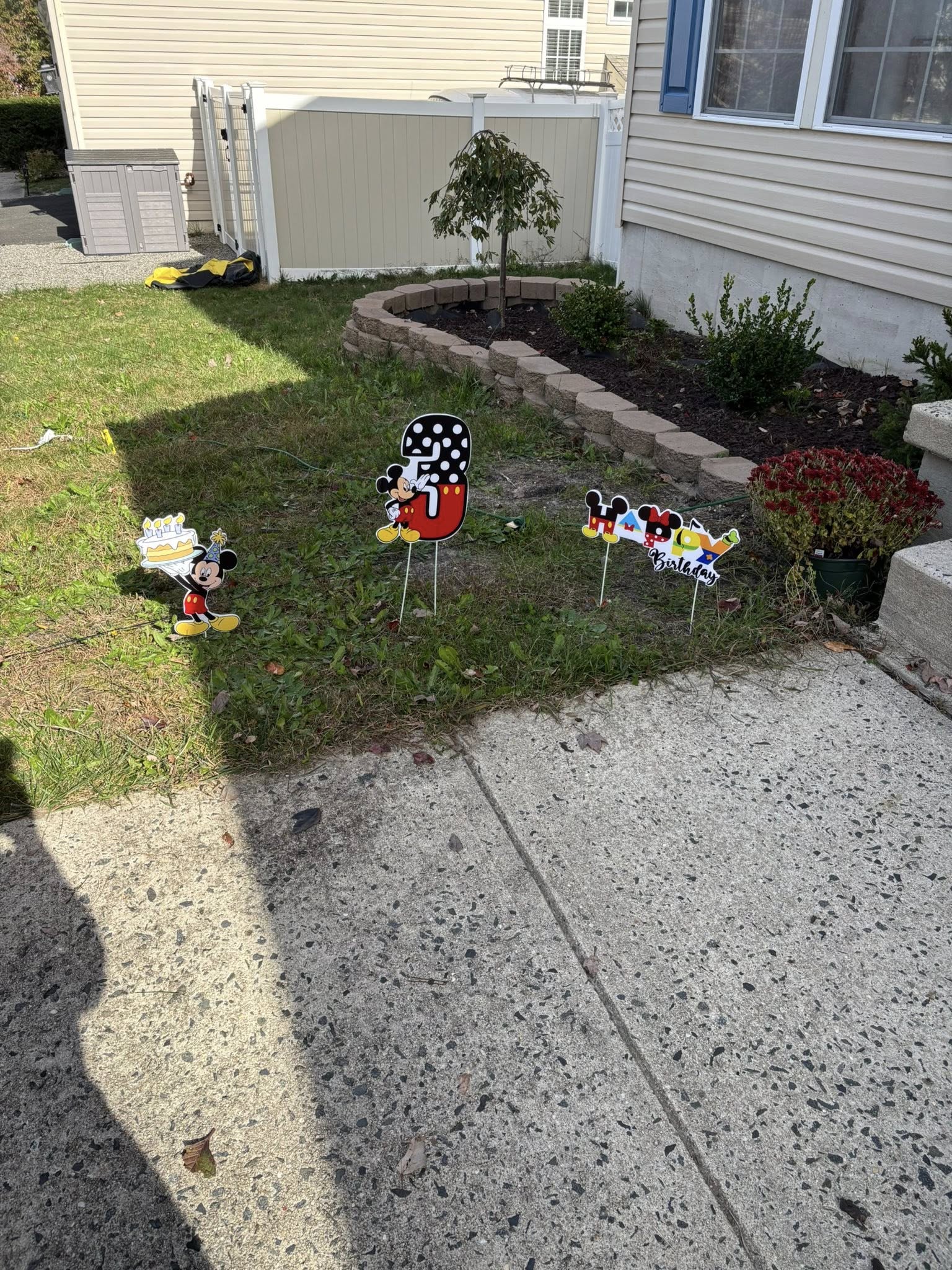 Mickey Mouse themed Happy 3rd Birthday yard signs standing in a grassy yard