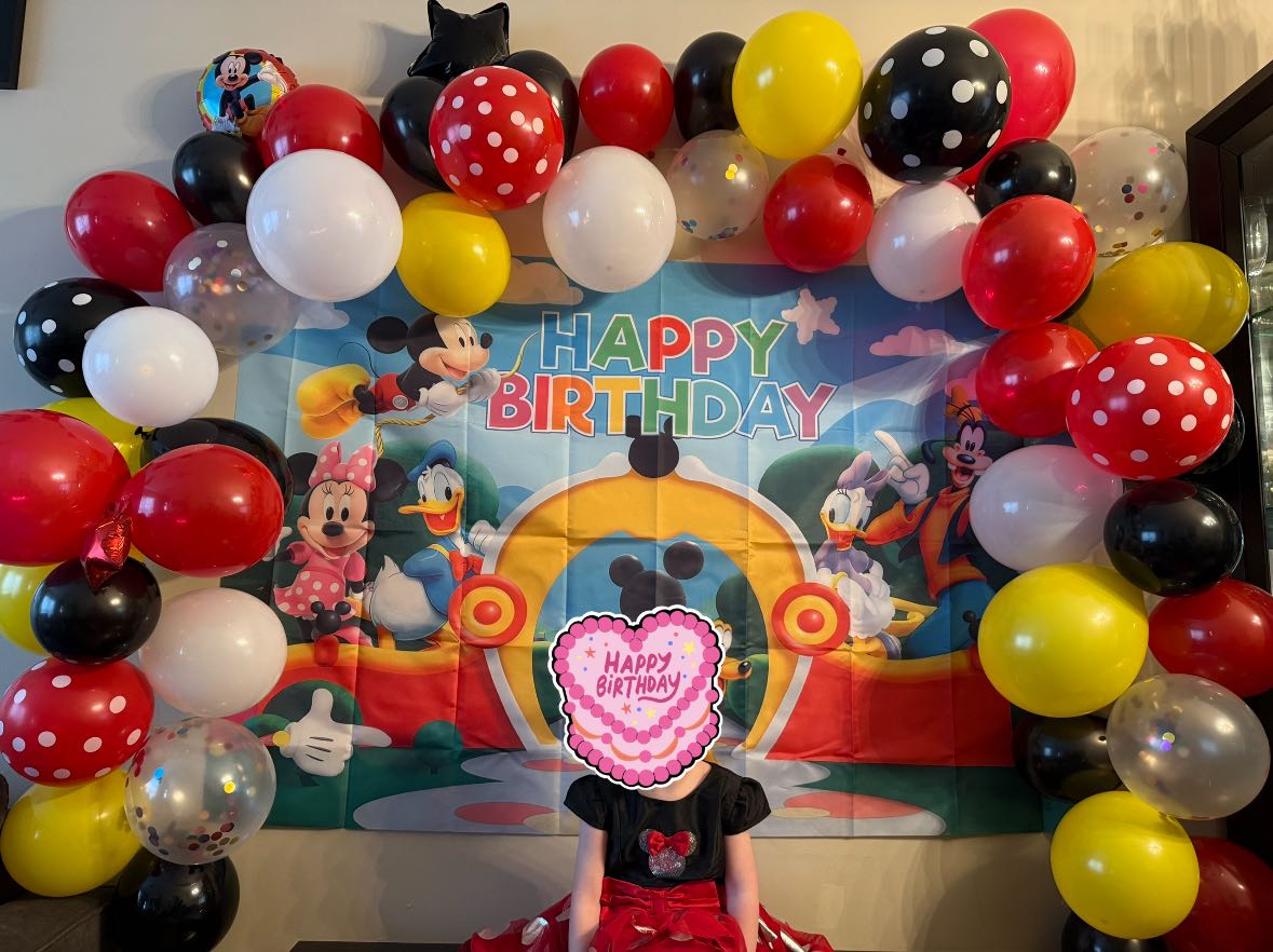 Mickey Mouse themed birthday party backdrop and balloon garland