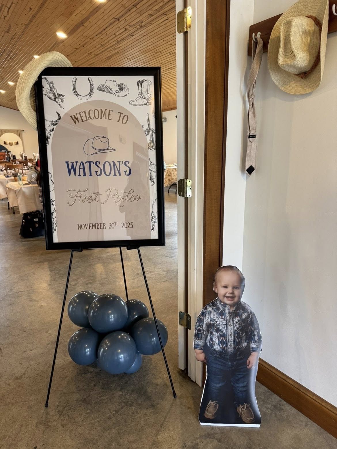 Welcome sign for Watson's First Rodeo event with a matching cutout of the birthday boy.