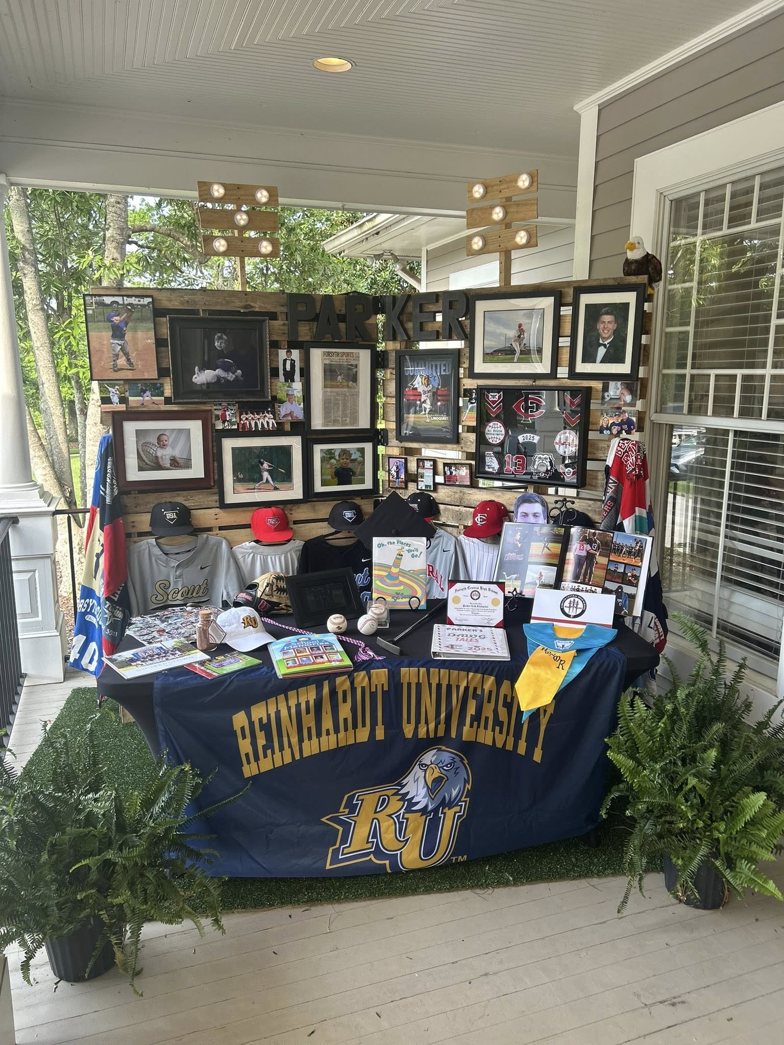 Graduation party display for Parker featuring baseball memorabilia and a Reinhardt University banner