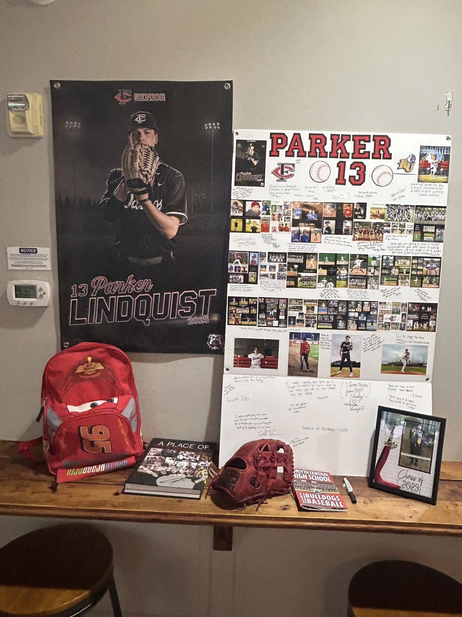 Senior baseball tribute display with player posters, a backpack, baseball glove, and Class of 2025 picture frame.