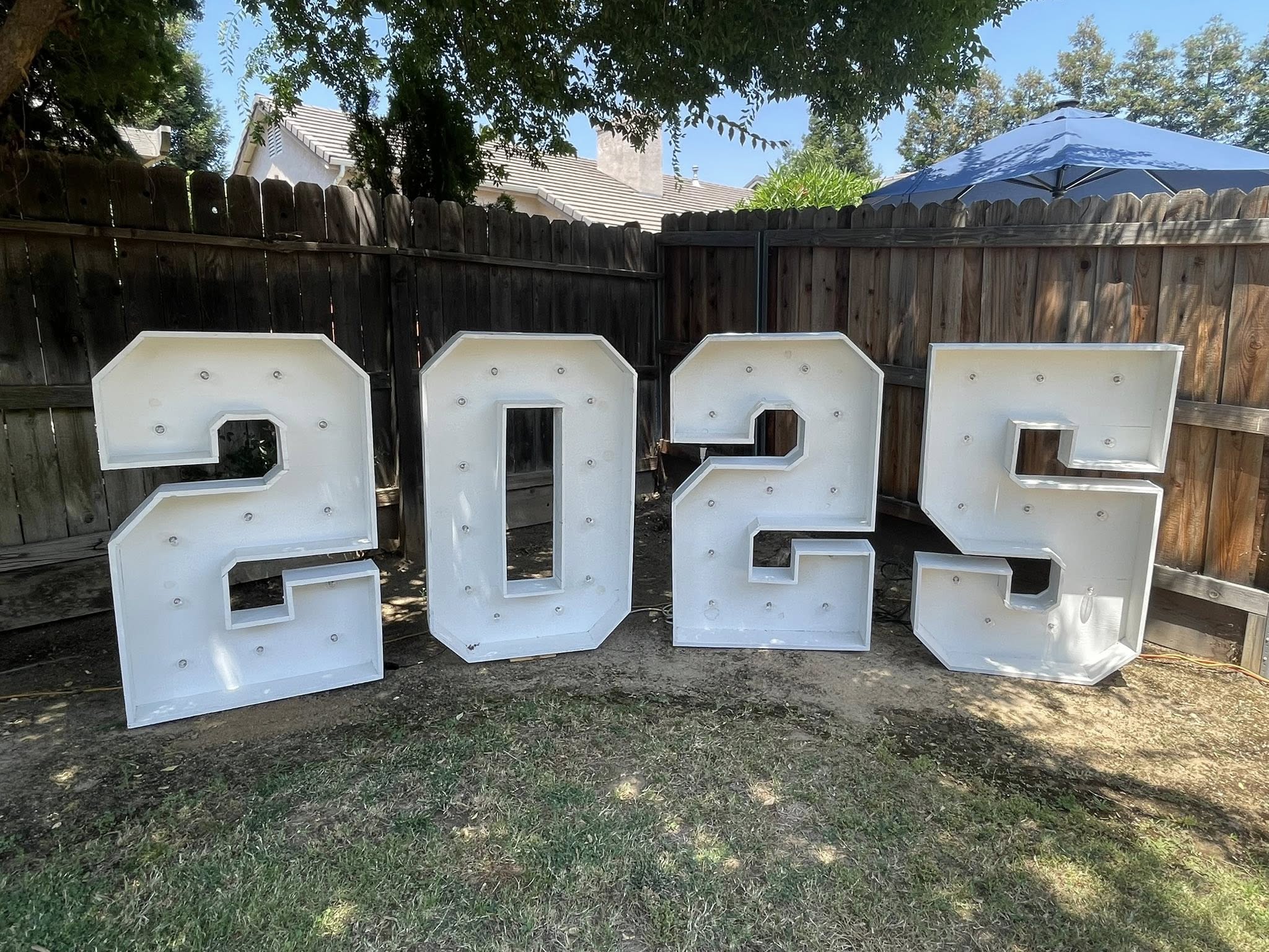 Large white marquee-style 2025 numbers for event decor