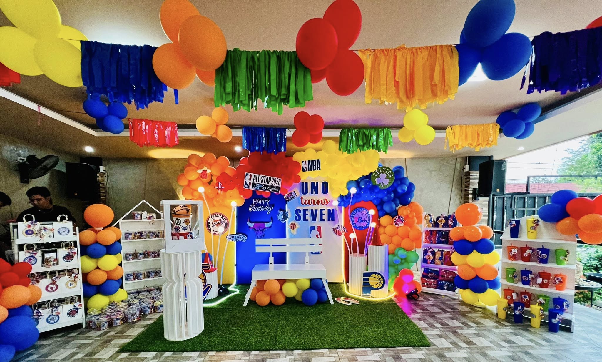 NBA themed birthday party decorations with colorful balloons, basketball logos, and party favors.