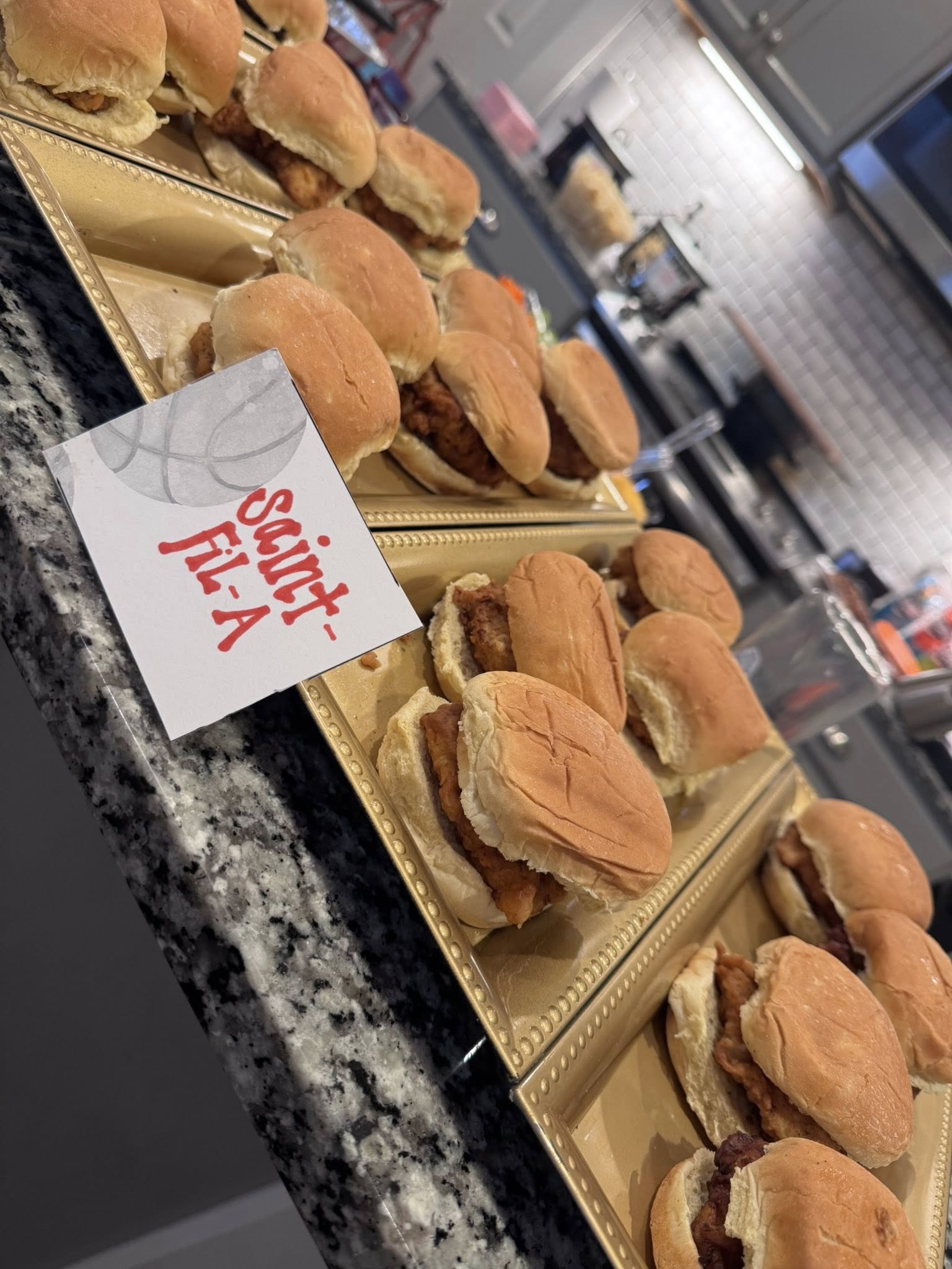 Tray of chicken sliders with a sign reading Saint-Fil-A